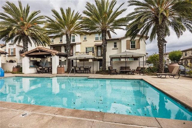 view of pool featuring a gazebo, an outdoor bar, and a patio area