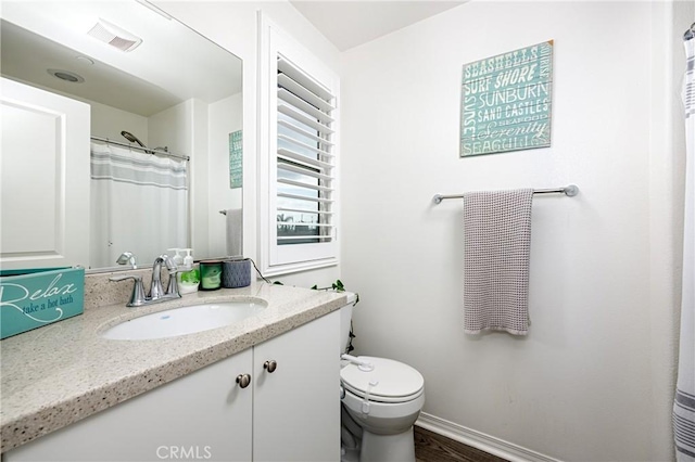 bathroom with vanity and toilet