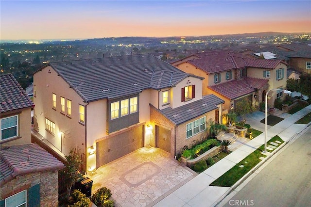 2598 E Temblor Ranch Dr, Brea, CA 92821 - view of front of house featuring an attached garage, stucco siding, driveway, and a residential view