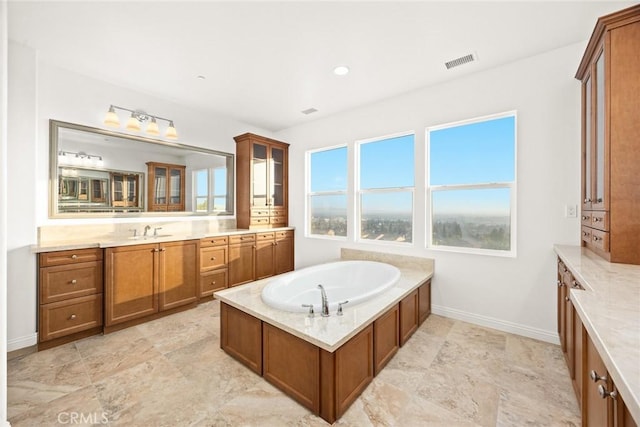 bathroom featuring vanity and a bath