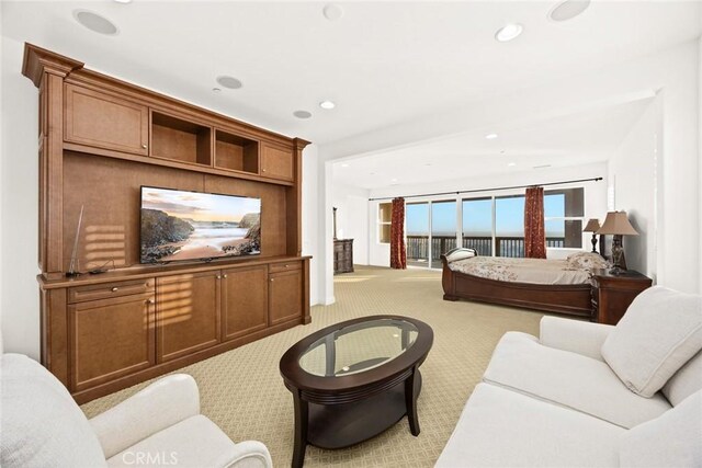 carpeted bedroom featuring a wall of windows