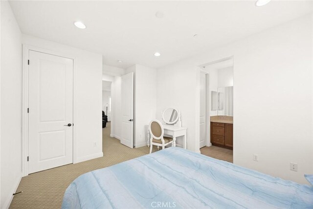 carpeted bedroom featuring ensuite bath