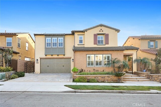 2598 E Temblor Ranch Dr, Brea, CA 92821 - view of front of home with driveway, an attached garage, stucco siding, and brick siding