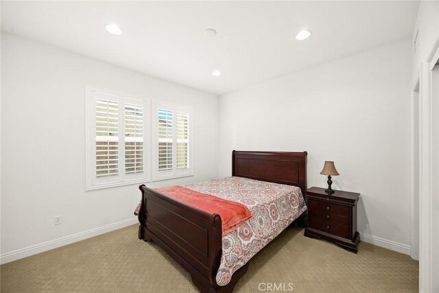 bedroom featuring light carpet