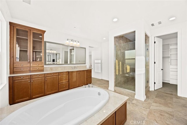 2598 E Temblor Ranch Dr, Brea, CA 92821 - bathroom featuring a stall shower, a walk in closet, a garden tub, vanity, and recessed lighting