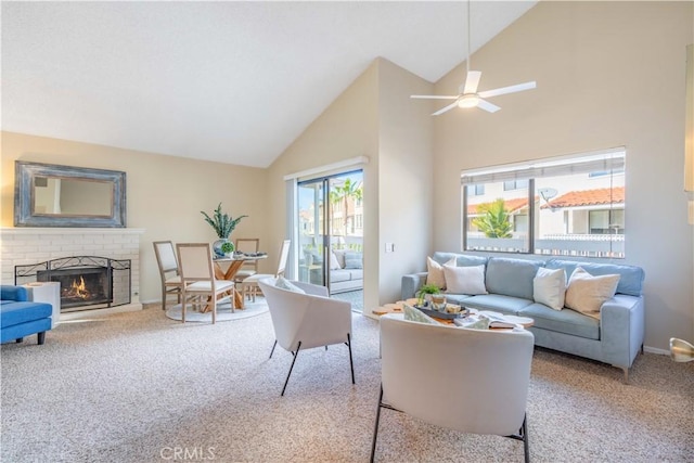 living room featuring a brick fireplace, high vaulted ceiling, ceiling fan, and carpet flooring