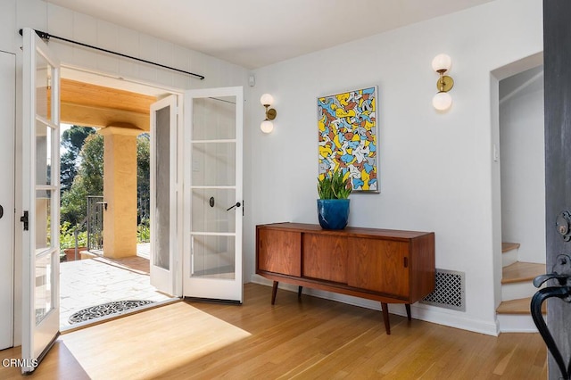 entryway featuring french doors and light wood-type flooring