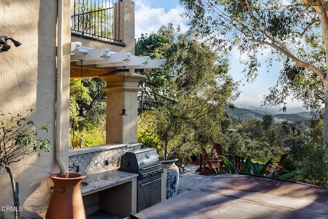 view of patio / terrace with a mountain view, area for grilling, and grilling area