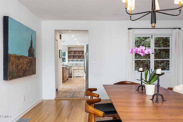 dining area featuring a chandelier and light hardwood / wood-style floors