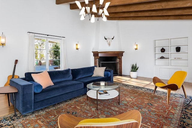 living room featuring beamed ceiling, an inviting chandelier, and hardwood / wood-style flooring