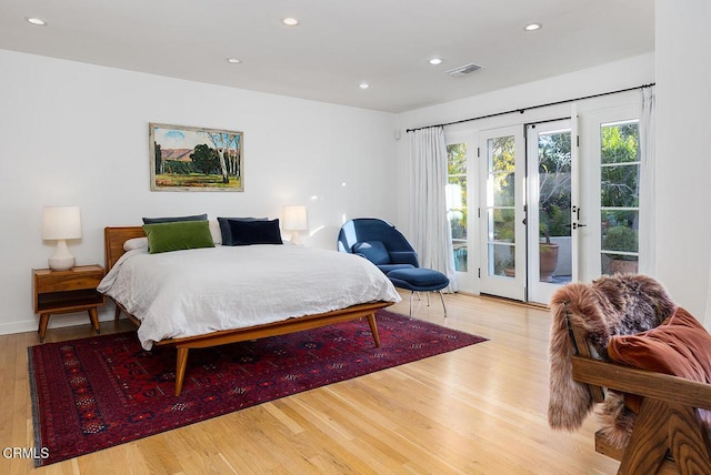 bedroom featuring access to exterior and light hardwood / wood-style floors