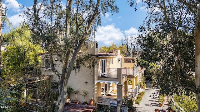 view of side of home with a balcony