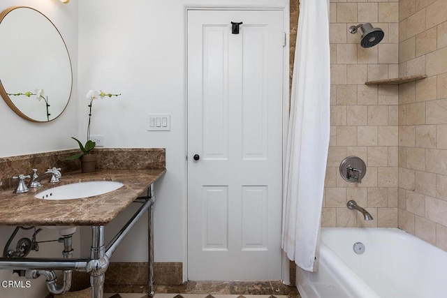 bathroom with sink and shower / bath combo with shower curtain