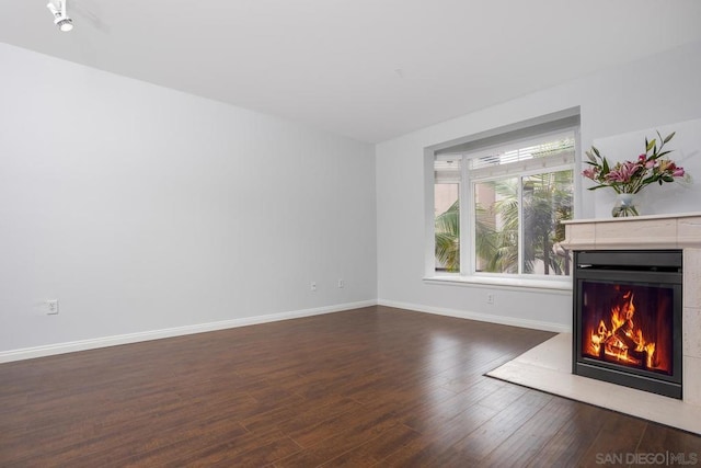 unfurnished living room with dark hardwood / wood-style flooring