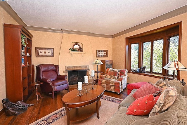 living room with a brick fireplace, wood-type flooring, ornamental molding, and a textured ceiling