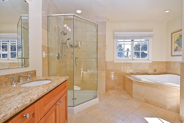 bathroom featuring vanity, tile patterned floors, and separate shower and tub