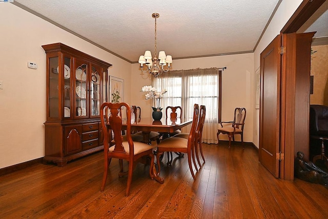 dining area with dark wood-type flooring, crown molding, a chandelier, and a textured ceiling