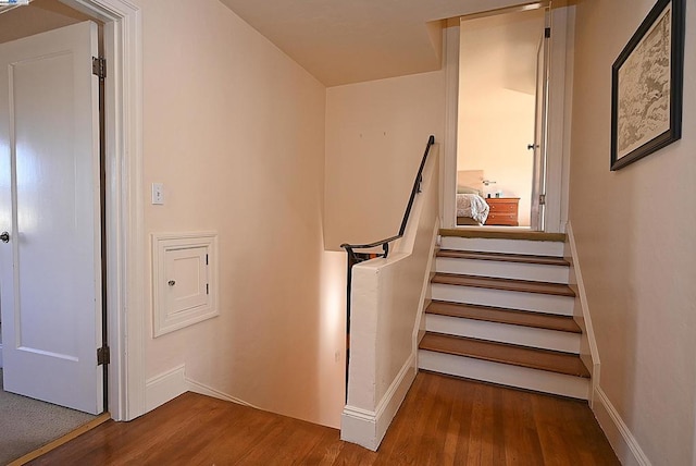 stairs featuring wood-type flooring