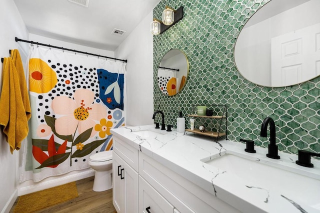 bathroom featuring toilet, tasteful backsplash, wood-type flooring, vanity, and curtained shower