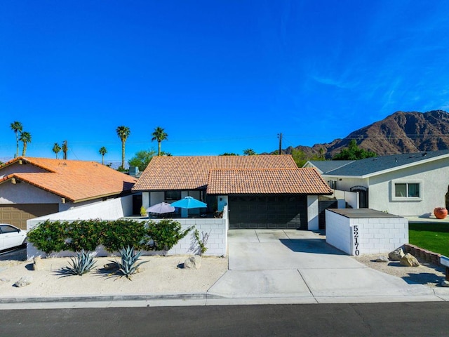 ranch-style home with a mountain view and a garage