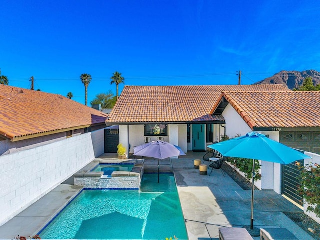 view of pool featuring an in ground hot tub and a patio area