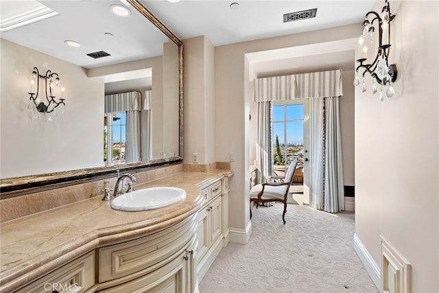 bathroom with baseboards, vanity, and visible vents
