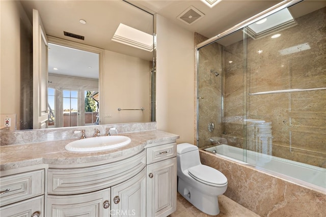 full bathroom with toilet, vanity, visible vents, and combined bath / shower with glass door