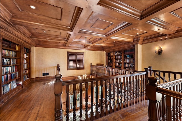 interior space featuring crown molding, an upstairs landing, hardwood / wood-style floors, wood ceiling, and built in features