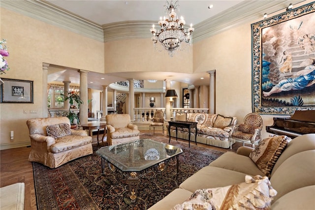 living room featuring a notable chandelier, hardwood / wood-style flooring, ornamental molding, and decorative columns