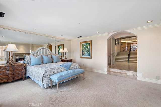 bedroom featuring arched walkways, carpet flooring, baseboards, and recessed lighting