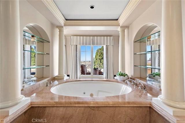 bathroom with decorative columns, a jetted tub, and crown molding