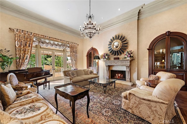 living room with ornamental molding, a notable chandelier, and french doors