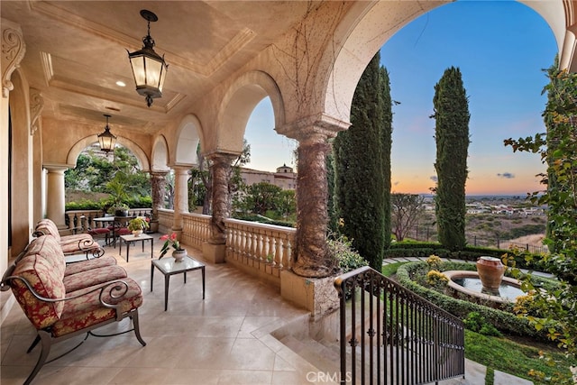 patio terrace at dusk featuring ceiling fan and an outdoor living space