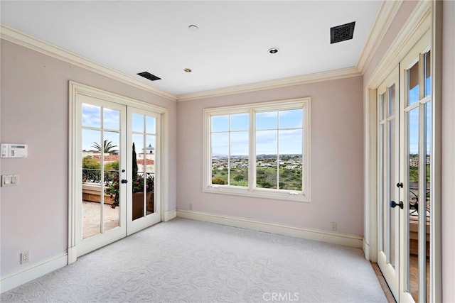 entryway featuring baseboards, crown molding, light colored carpet, and french doors