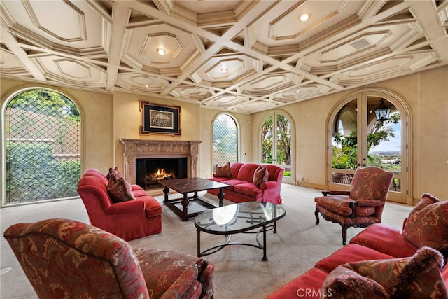 living area with carpet flooring, a lit fireplace, and coffered ceiling