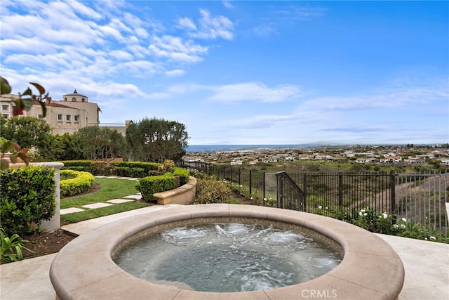 view of home's community with fence and a jacuzzi