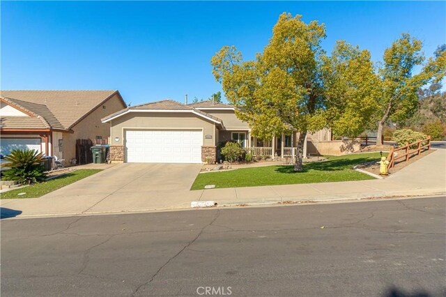 view of front of home with a garage and a front lawn