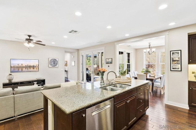 kitchen featuring sink, dishwasher, a kitchen island with sink, dark hardwood / wood-style floors, and light stone countertops