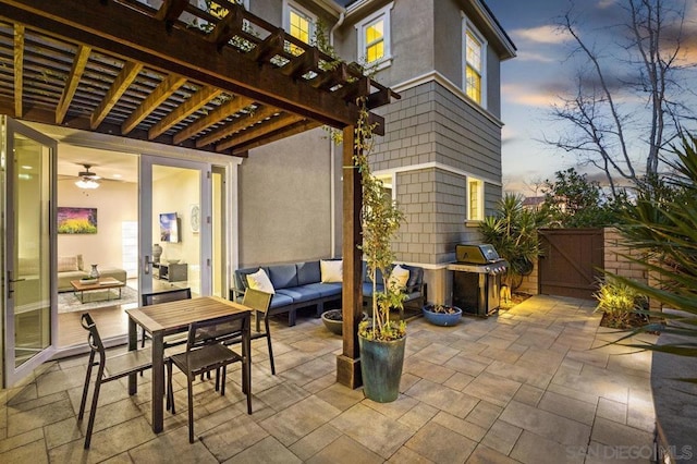 patio terrace at dusk featuring an outdoor living space, area for grilling, and a pergola