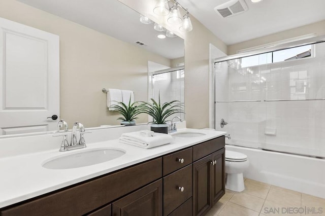 full bathroom with vanity, tile patterned floors, shower / bath combination with glass door, and toilet