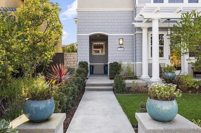 entrance to property featuring a pergola