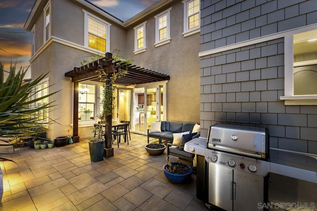 patio terrace at dusk featuring a pergola and an outdoor hangout area