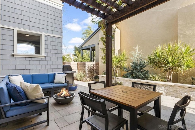 view of patio featuring a pergola and an outdoor living space with a fire pit