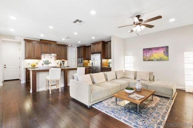 living room with sink, dark hardwood / wood-style floors, and ceiling fan