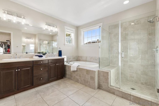 bathroom featuring vanity, tile patterned flooring, and plus walk in shower