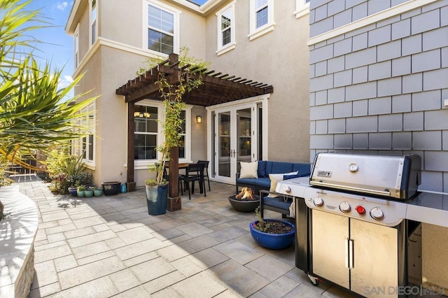 view of patio with a grill, a pergola, french doors, and an outdoor fire pit