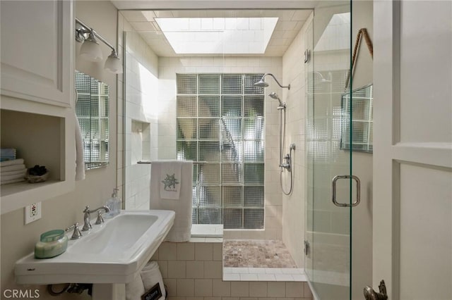 bathroom featuring sink and a shower with door