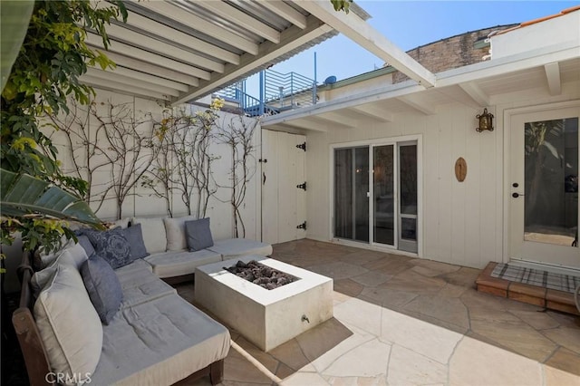 view of patio / terrace featuring an outdoor living space with a fire pit