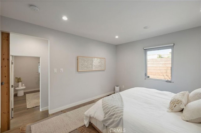 bedroom with wood-type flooring and ensuite bathroom