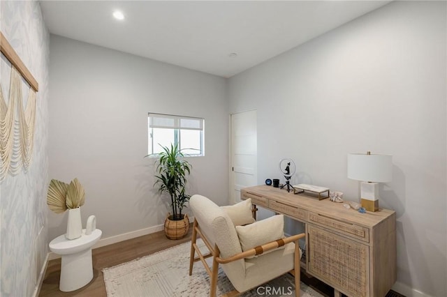 home office with light hardwood / wood-style flooring